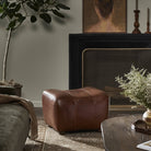 Four Hands Kylo Ottoman in Dulane Mahogany in a modern neutral living room at Addison West