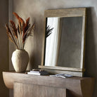 Four Hands Ledge Wall Mirror in Distressed Light Pine on a sideboard at Addison West