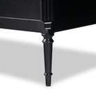 Close up of leg of Four Hands Lendon 6 Drawer Dresser in Black on a white background