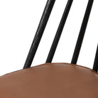 Close up of Four Hands Lewis Windsor Chair in Black Whiskey Saddle on a white background