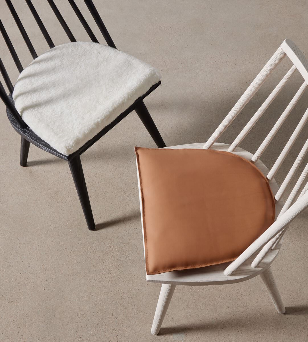 Four Hands Lewis Windsor Chair in Black Whiskey Saddle on a beige background