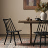 Four Hands Lewis Windsor Chair in Black oak in a modern dining room