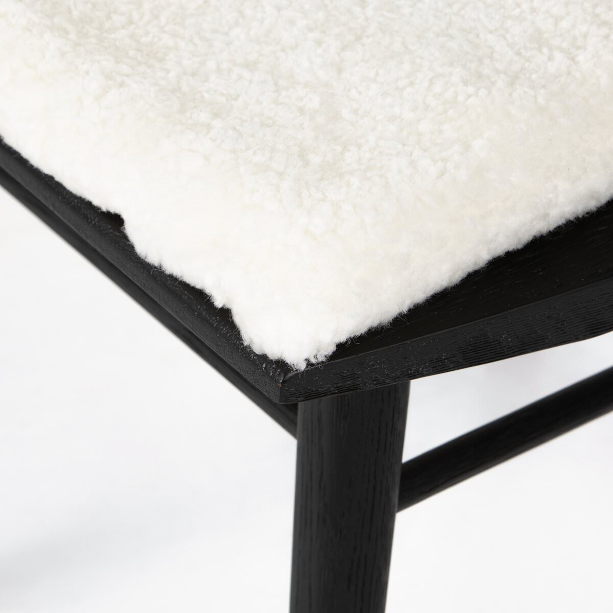 Close up of Four Hands Lewis Windsor Chair in Cream Shorn Sheepskin on a white background