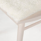 Close up of Four Hands Lewis Windsor Chair in Cream Shorn Sheepskin on a white background