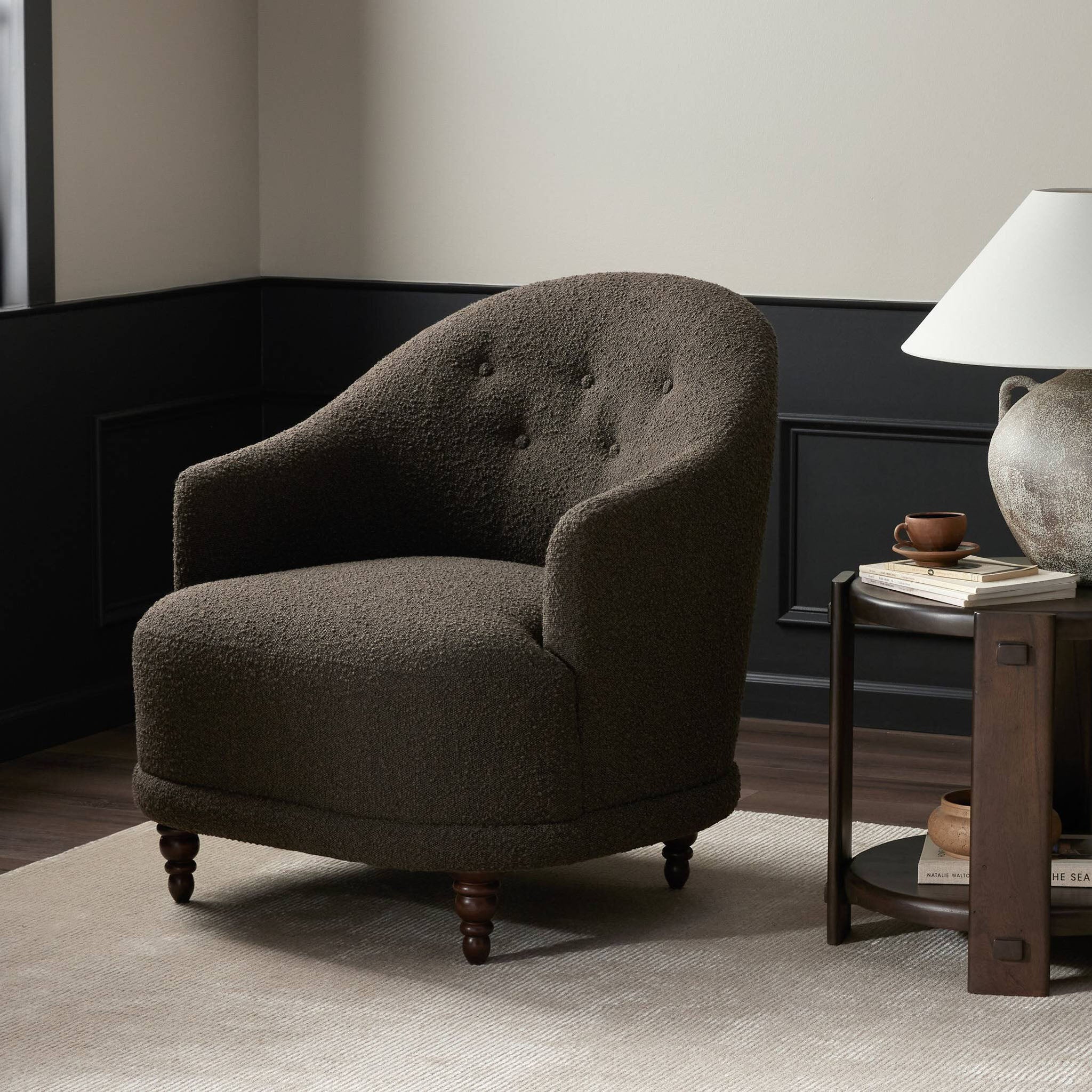 Four Hands Marnie Chair in Knoll Mink in a living room with wood paneling and a rustic white lamp