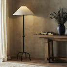 Four Hands Neville Floor Lamp in Matte Black Cast Aluminum in a living room