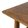 Close up of Four Hands Otto Dining Table 110" in Honey Pine on a white background
