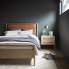 Four Hands Rosedale Bed Bed in Chaps Sand in a modern bedroom with dark grey green walls