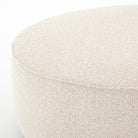 Corner of Four Hands Sinclair Large Round Ottoman in Knoll Natural on a white background at Addison West