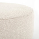 Corner of Four Hands Sinclair Large Round Ottoman in Knoll Natural on a white background at Addison West