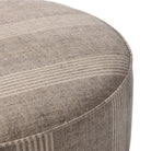 Close up of Four Hands Sinclair Large Round Ottoman in Manchester Flint on a white background at Addison West