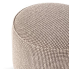 Close up of Four Hands Sinclair Round Ottoman in Barrow Taupe on a white background