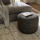 Four Hands Sinclair Round Ottoman in Ivan Granite in a neutral living room