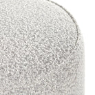 Close up of Four Hands Sinclair Round Ottoman in Knoll Domino on a white background