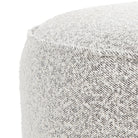 Close up of Four Hands Sinclair Round Ottoman in Knoll Domino on a white background