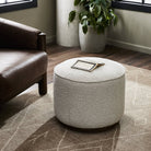 Four Hands Sinclair Round Ottoman in Knoll Natural in a living room