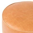 Close up of Four Hands Sinclair Round Ottoman in Palermo Butterscotch on a white background