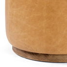 Close up of Four Hands Sinclair Round Ottoman in Palermo Butterscotch on a white background