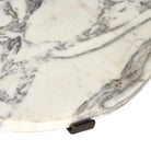 Close up of Four Hands Sophie End Table in Veined White Marble on a white background