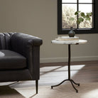 Four Hands Sophie End Table in Veined White Marble in a modern living room