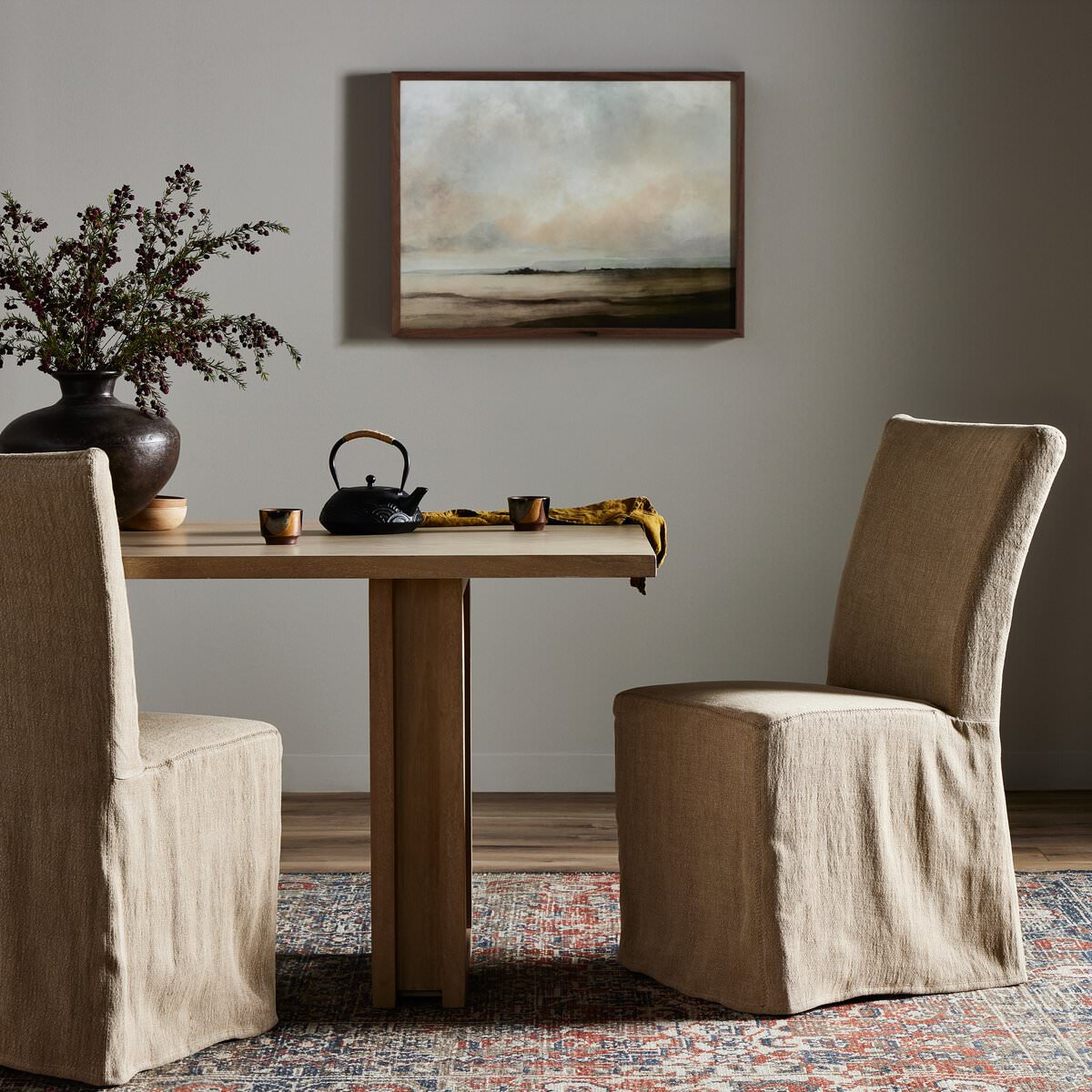 Four Hands Vista Slipcovered Dining Chair in Broadway Canvas at a modern minimalist dining table