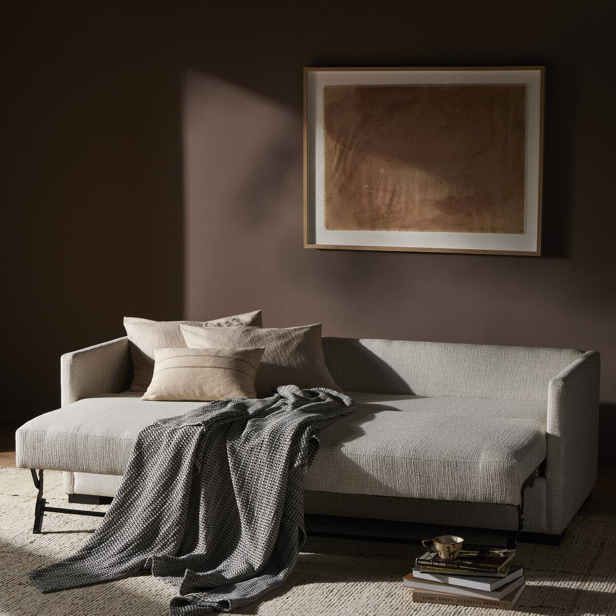 Four Hands Wickham Sofa Bed in Alameda Snow in a dark neutral room