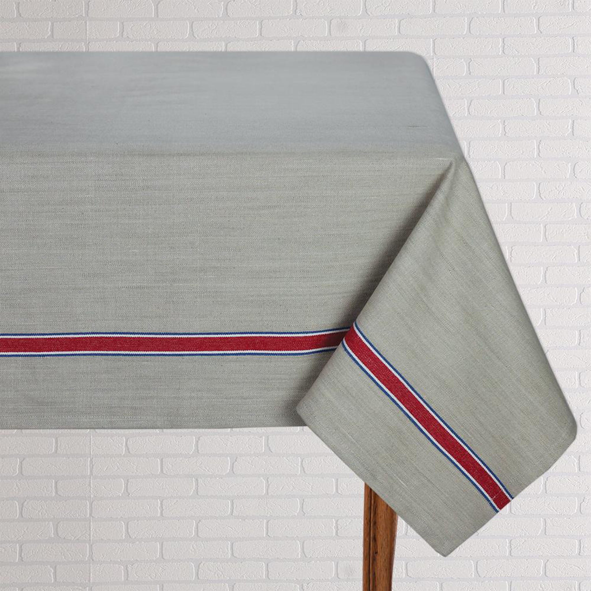 French Laundry Red Tablecloth  60" X 120" beige with red stripe on a white brick background