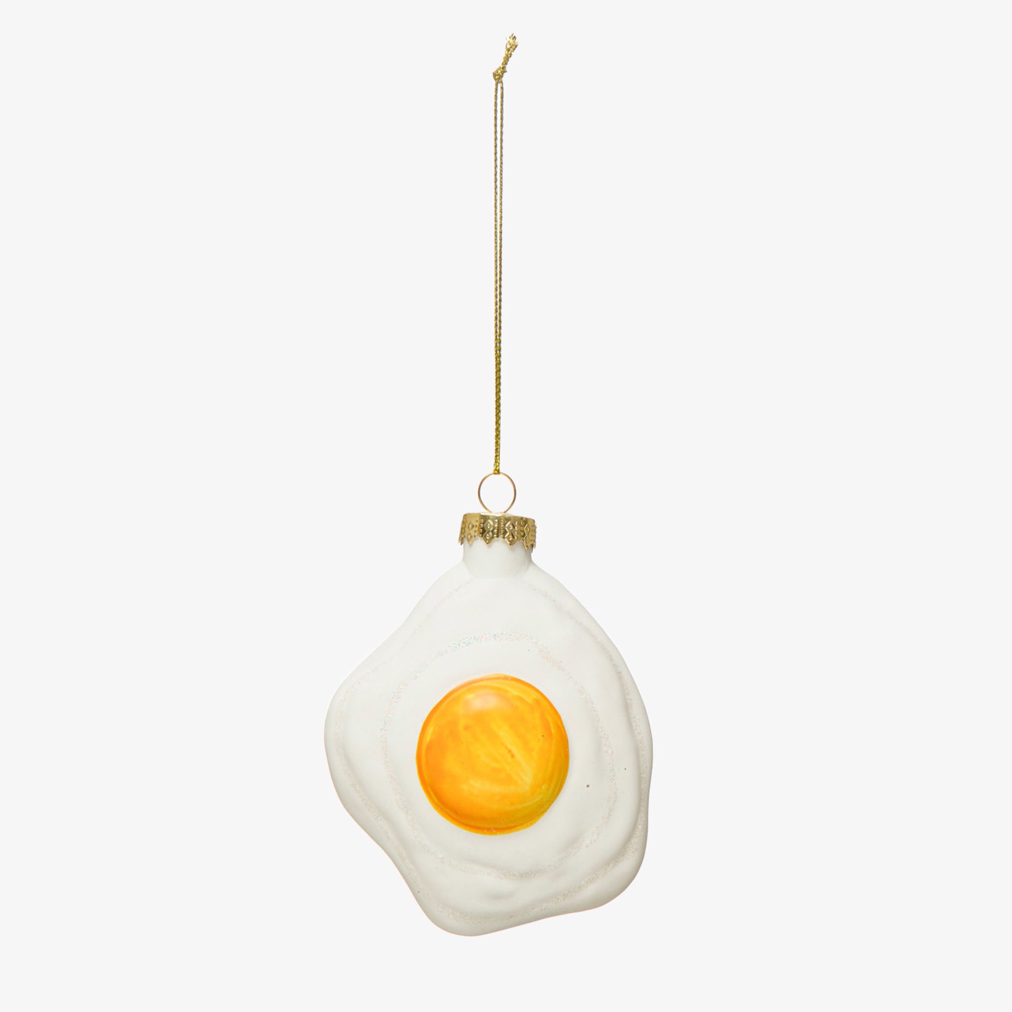 Glass sunny side up fried egg ornament on a white background