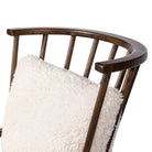 Four Hands Graham Chair with spindle back and shearling cushions on a white background