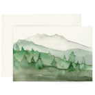 Watercolor greeting card featuring green mountains and trees on a white background