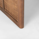 Close up of Grier 42" Square Medium Brown Solid Wood with Cane Coffee Table on a white background