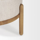 Close up of Gwynn Beige Fabric with Light Brown Wood Pouf on a white background