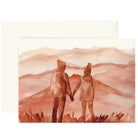 Watercolor greeting card with a couple holding hands looking out over mountains