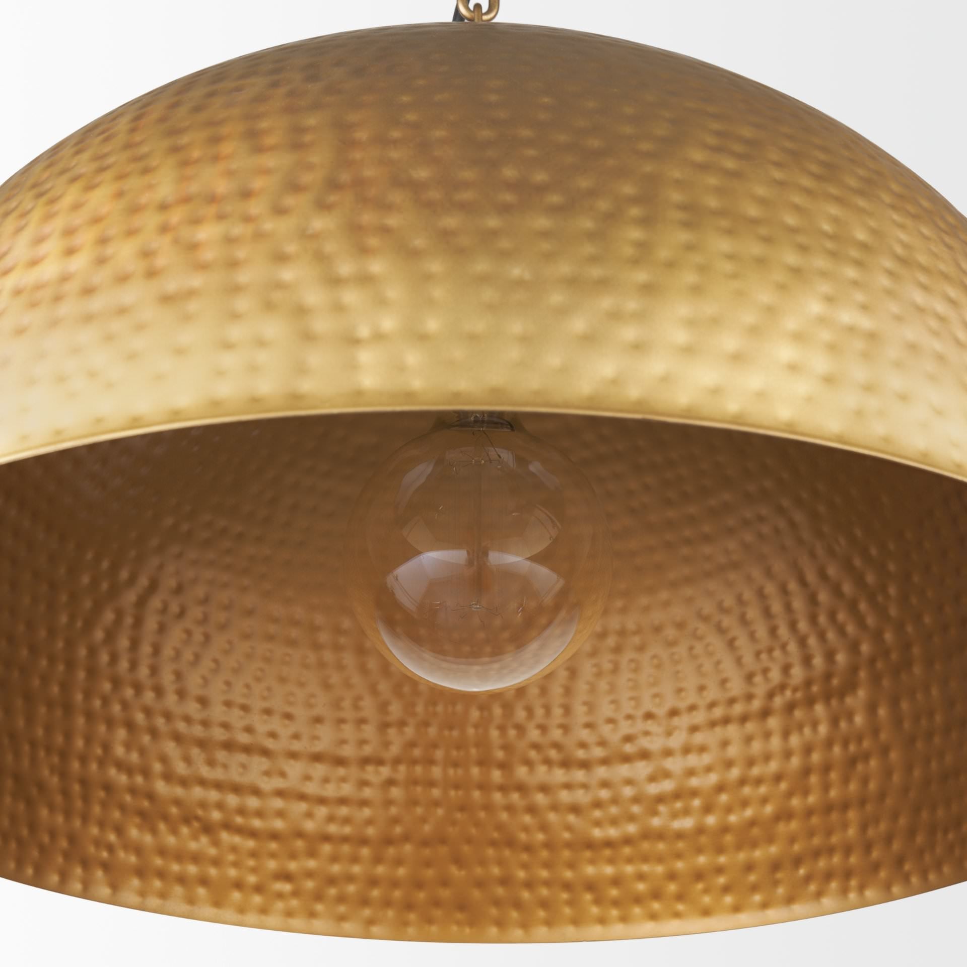 Close up of Karina 24" Round Brass-tone Hammered Metal Dome Pendant Light on a white background