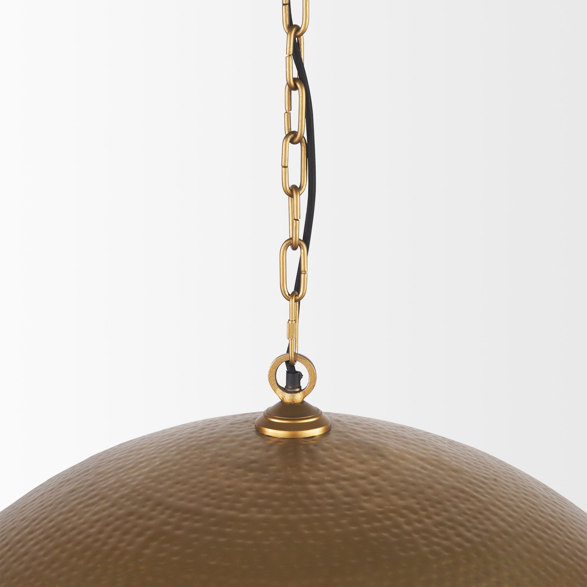 Close up of Karina 36" Round Brass-tone Hammered Metal Dome Pendant Light on a white background