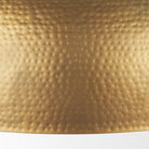 Close up of Karina 36" Round Brass-tone Hammered Metal Dome Pendant Light on a white background