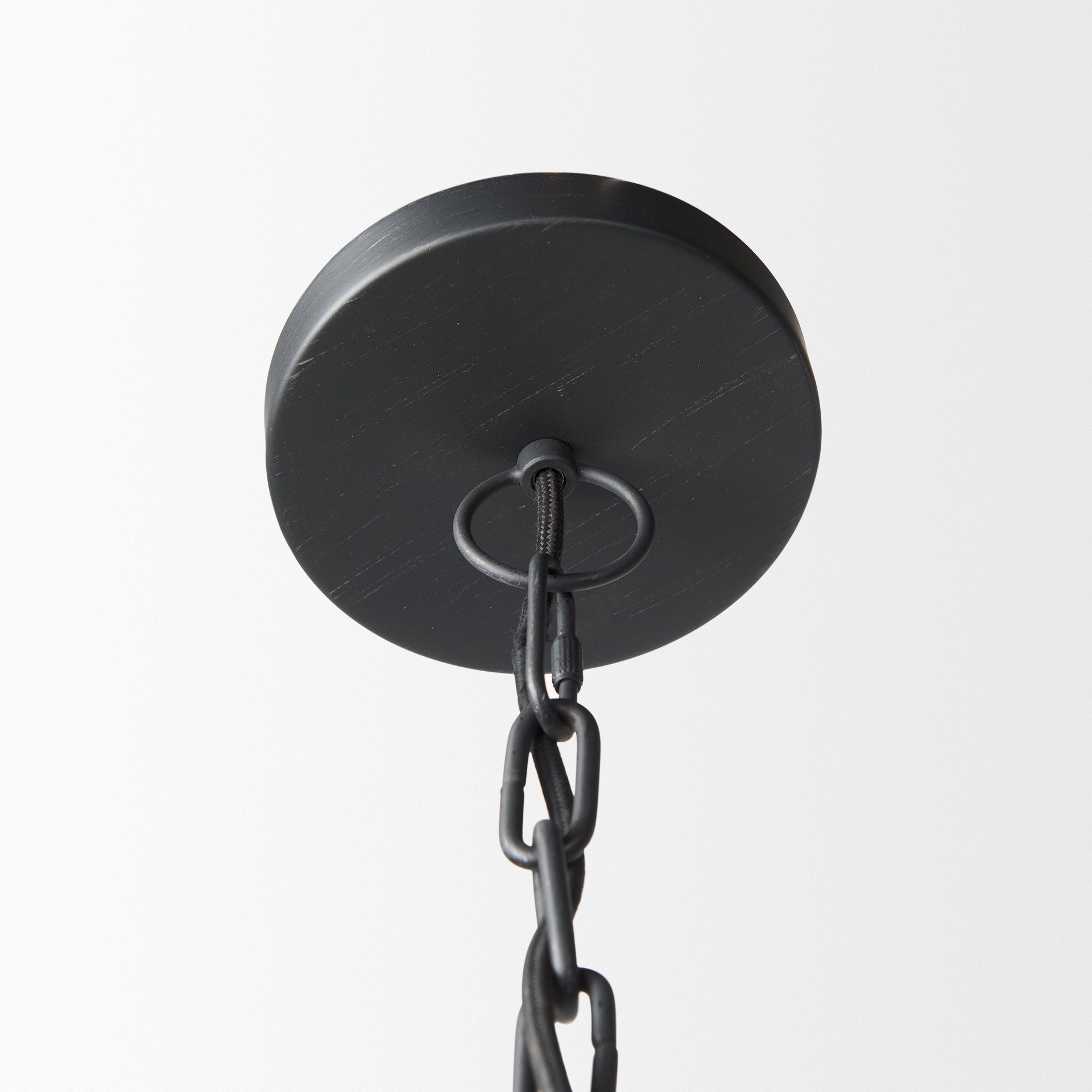 Close up of Karina 36" Round Matte Black Hammered Metal Dome Pendant Light on a white background