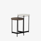 Round nesting side tables with black frames on a white background