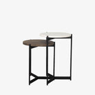 Round nesting side tables with black frames on a white background