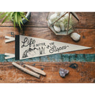 Life is Better on the Slopes Pennant on a wood table