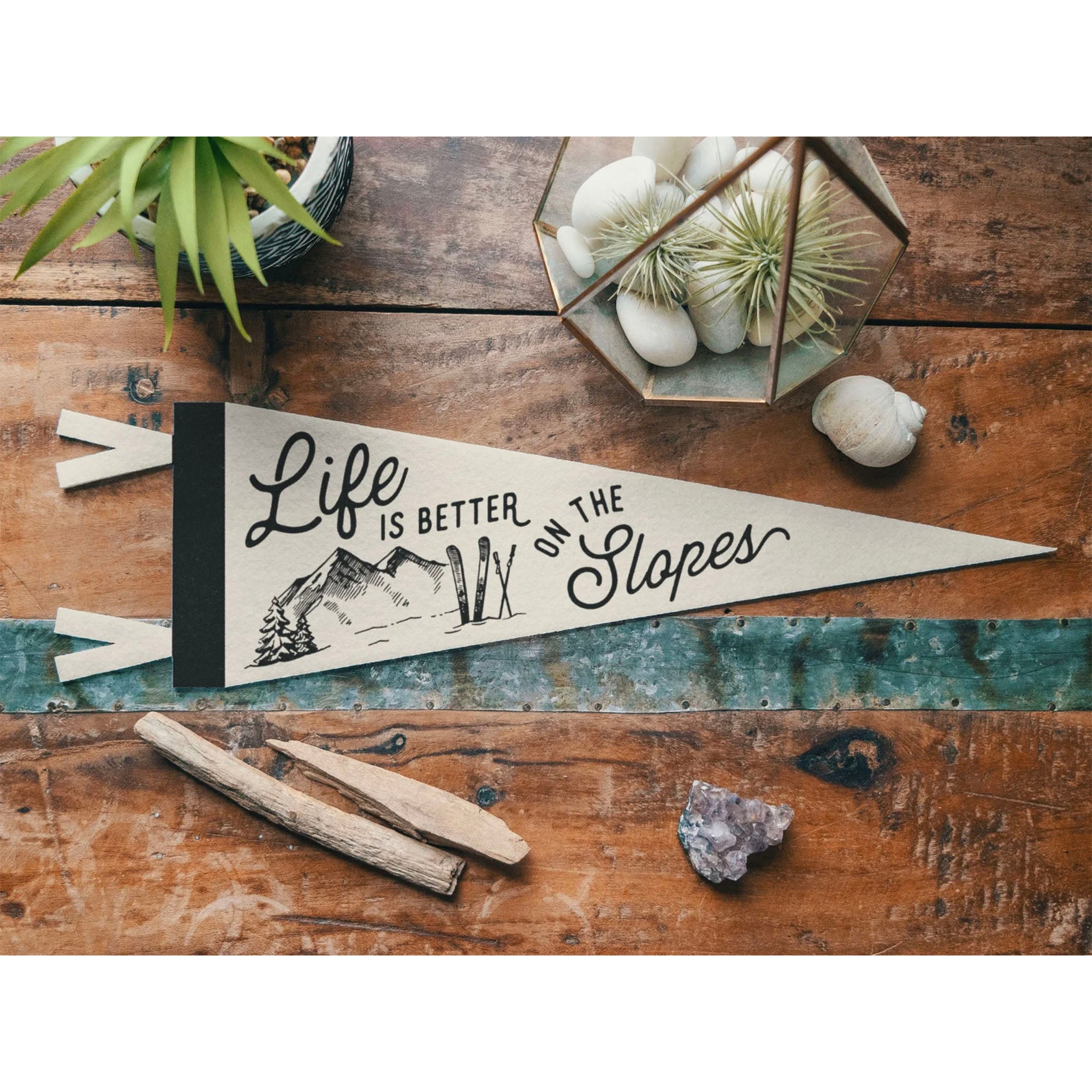 Life is Better on the Slopes Pennant on a wood table