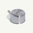 Bottom of Made In Stainless Clad 2 qt. Saucepan with Lid on a beige background at Addison West