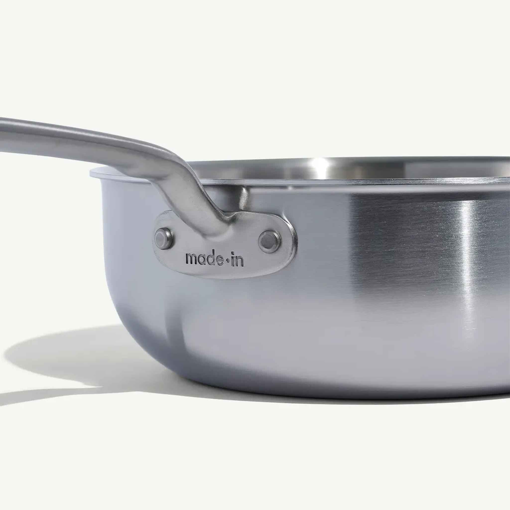 Close up of Made In Stainless Clad 3 qt. Saucepan with Lid on a beige background at Addison West