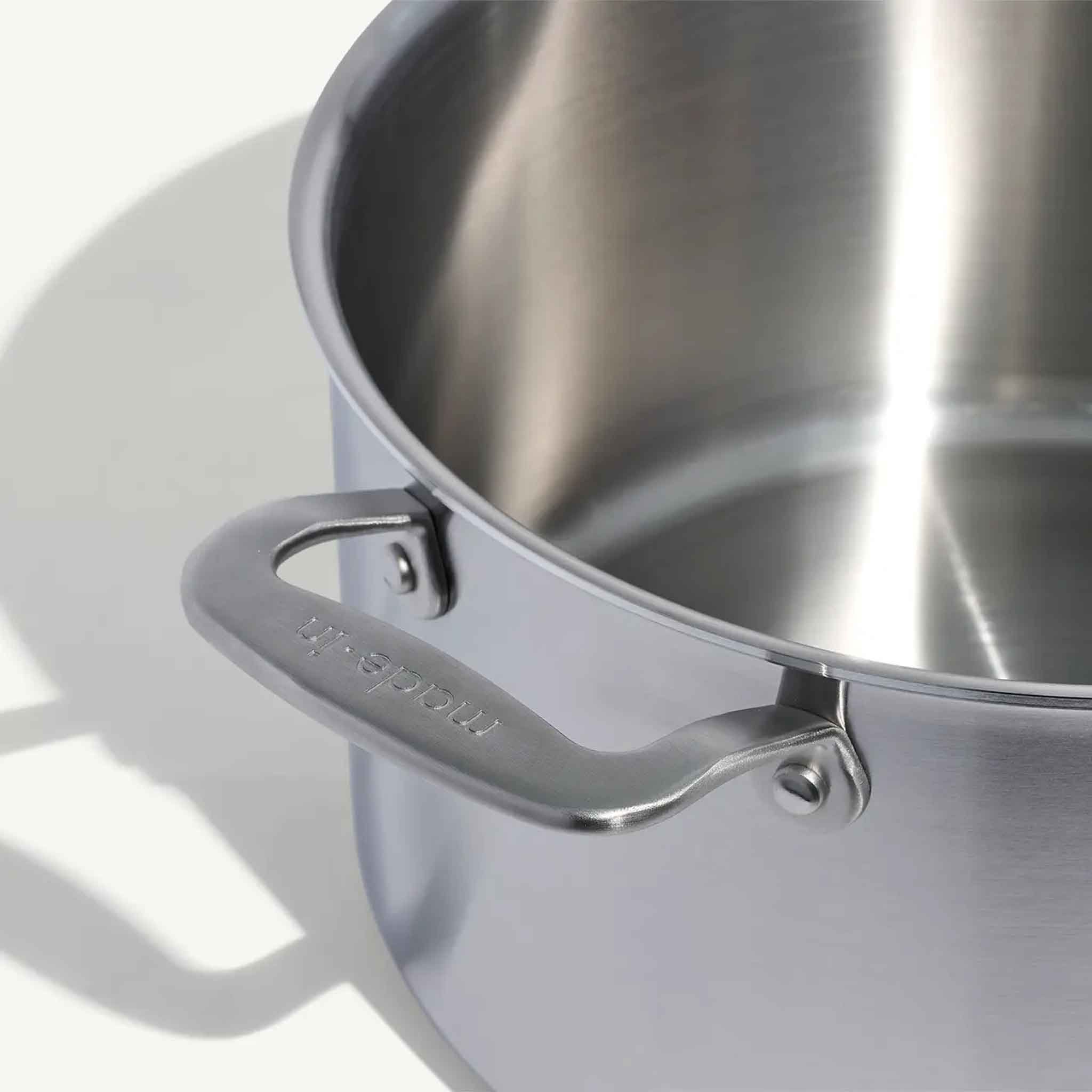 Close up of Made In Stainless Clad 8 qt. Stock Pot with Lid on a beige background at Addison West