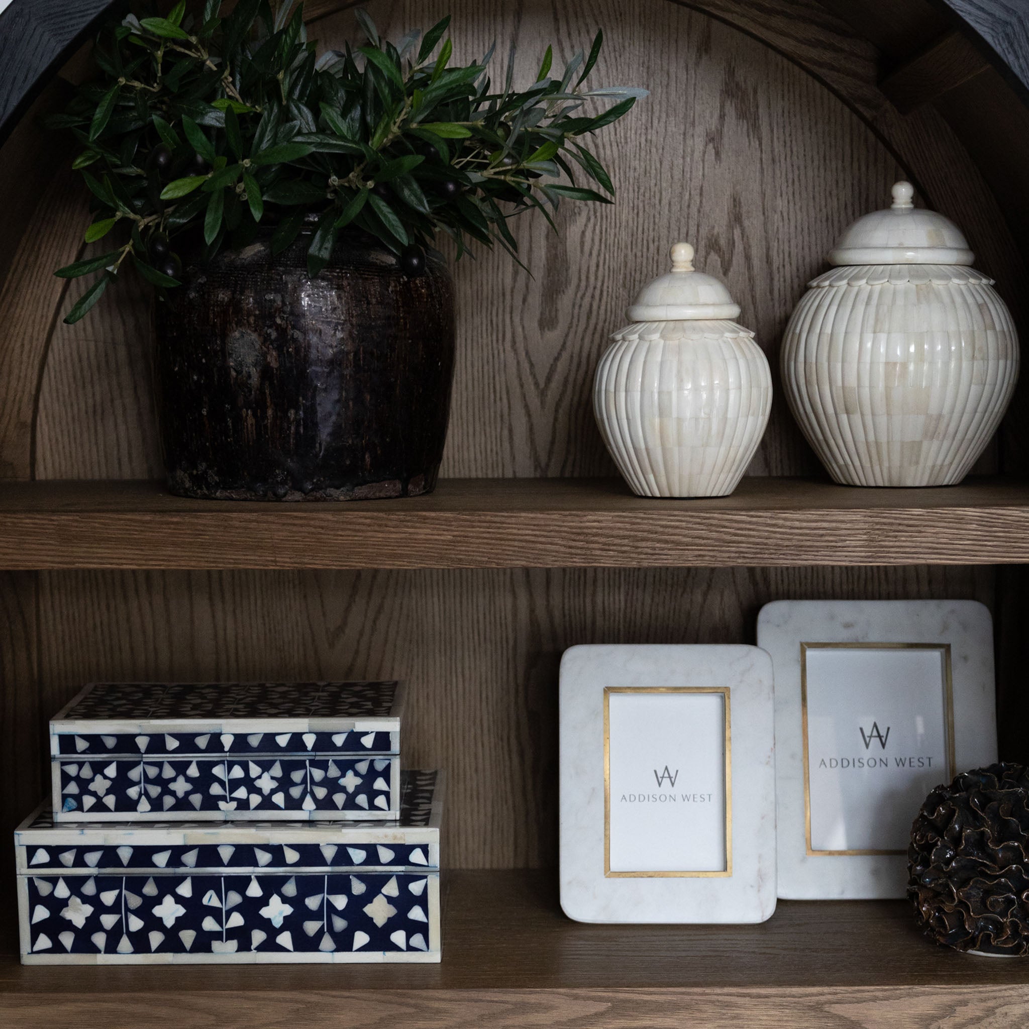 Two's company Minaret Mosaic Covered Jar in Bone/MDF on a shelf in a cabinet