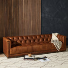 Four Hands furniture brand Maxx Chesterfield style Sofa in Heirloom Sienna leather on a white background