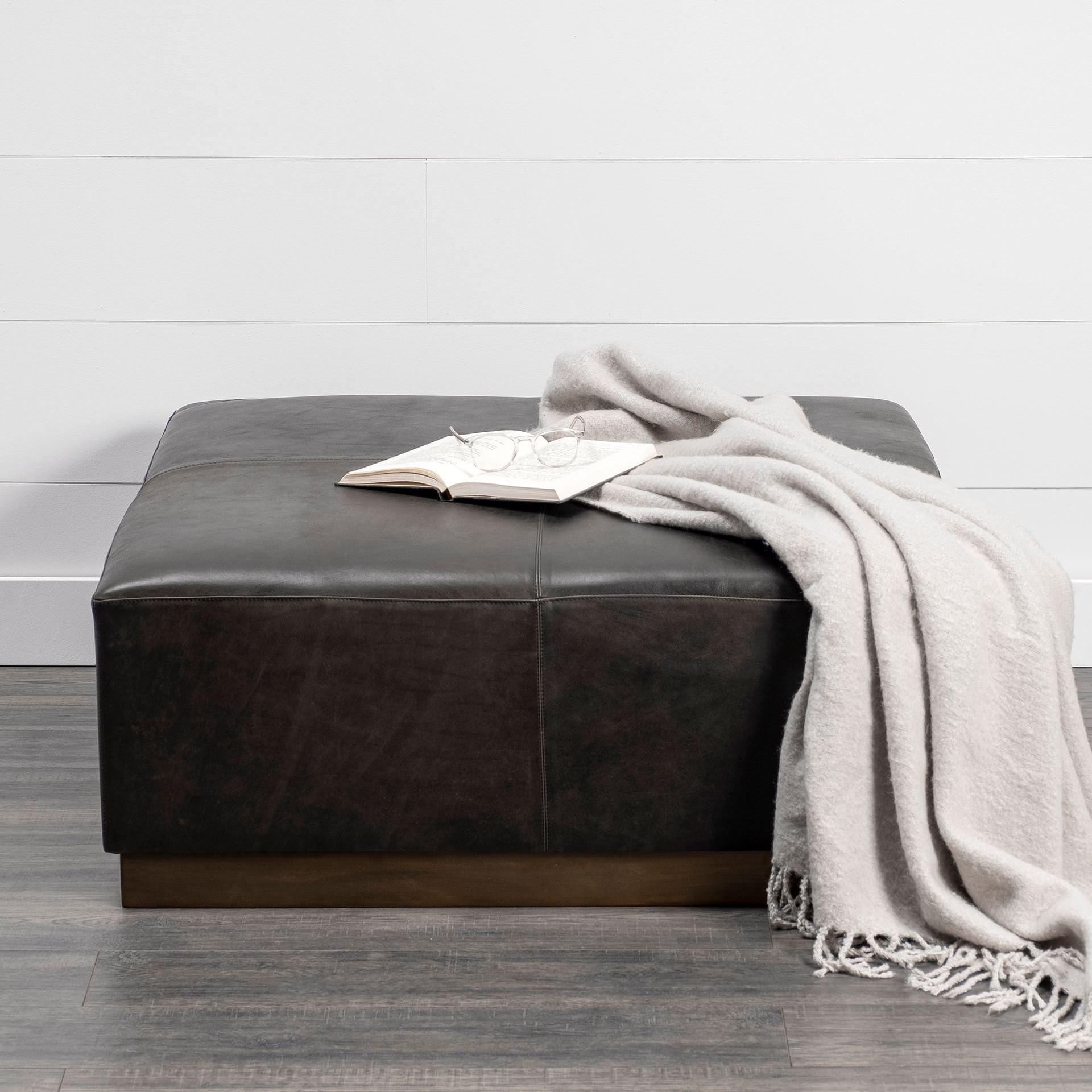 Minara 36" Square Black Leather Wrapped with Metal Base Ottoman in a farmhouse living room