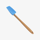 Small mini spatula with wood handle and blue silicone on a white background