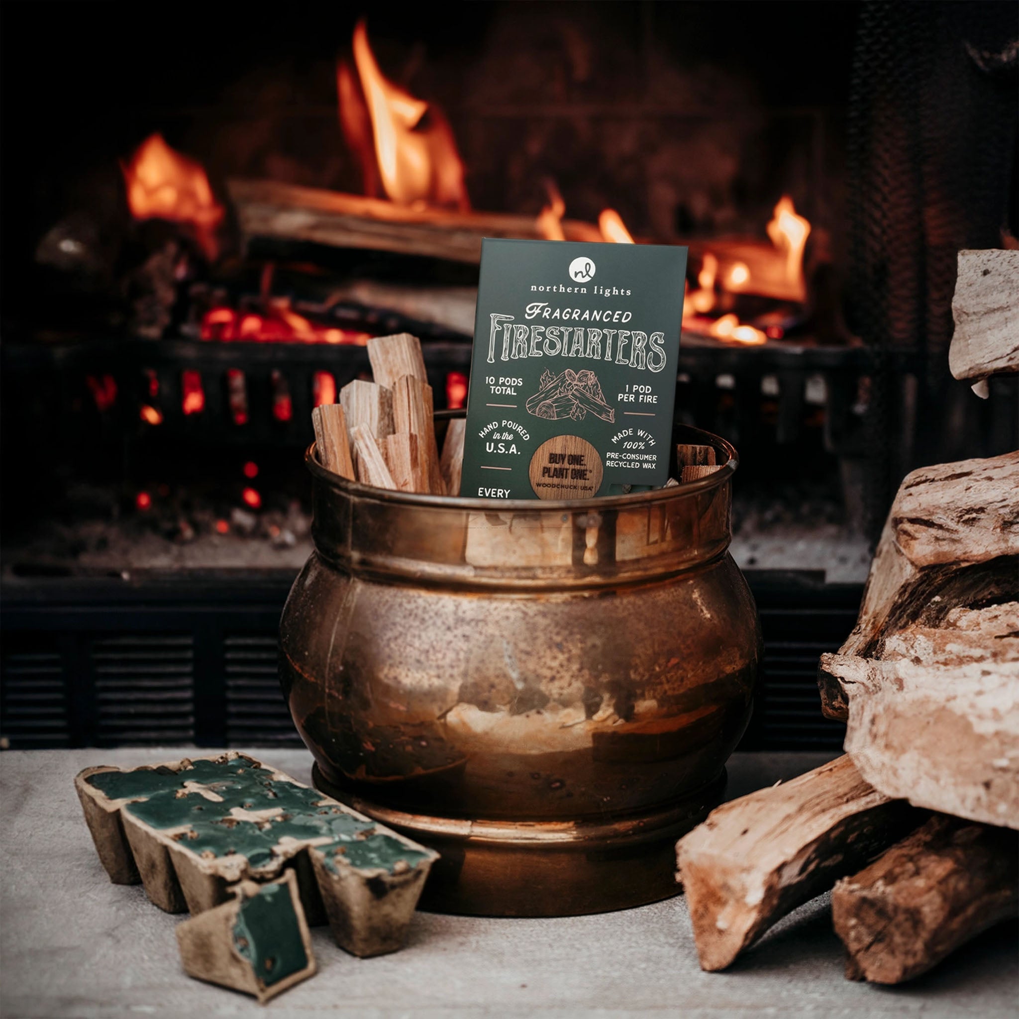 Copper pail with Northern Lights Firestarters - Evergreen Forest in front of a fire 