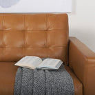 Close up of Olaf Tan Leather Sofa in a modern living room